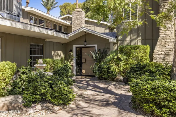 a kitchen with stainless steel appliances granite countertop a kitchen island a stove and a sink