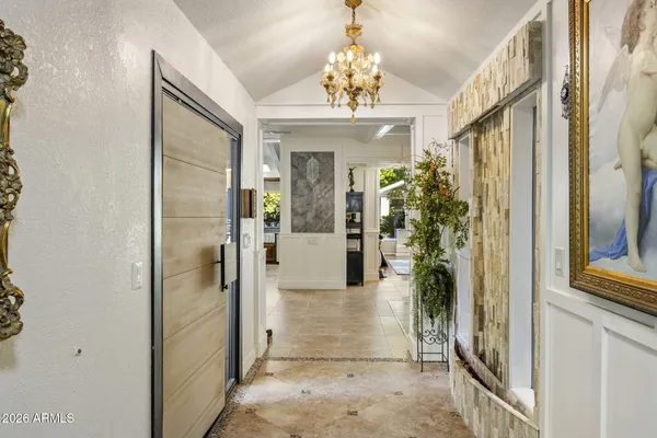 a living room with patio furniture and a large window