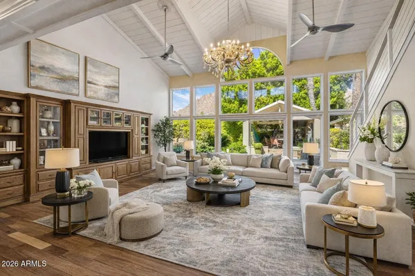 a living room with furniture windows and a flat screen tv