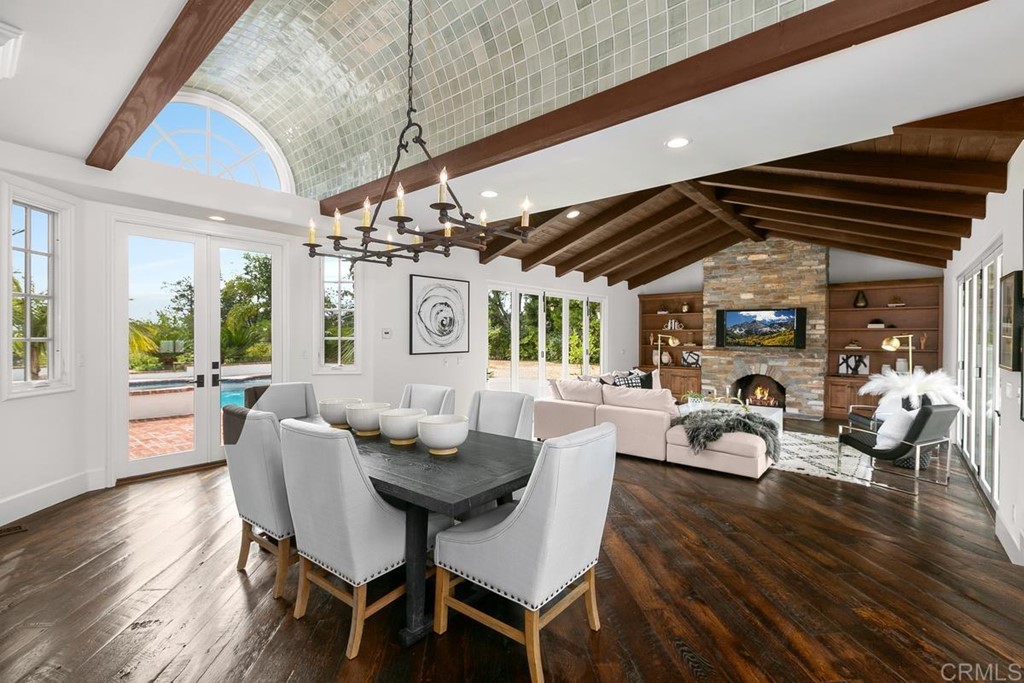 14910 Rancho Nuevo Del Mar, CA 92014 - Photo 12 of 54 a dining room with wooden floor furniture and a chandelier
