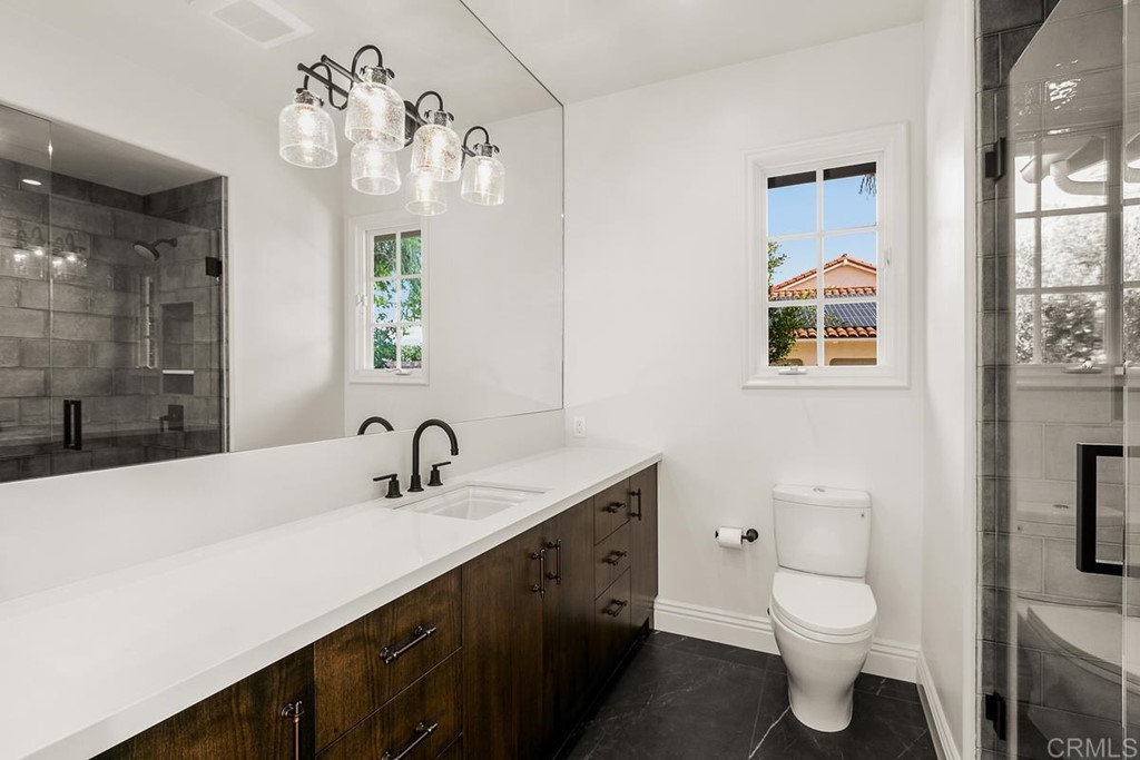 14910 Rancho Nuevo Del Mar, CA 92014 - Photo 35 of 54 a bathroom with a double vanity sink toilet and a mirror