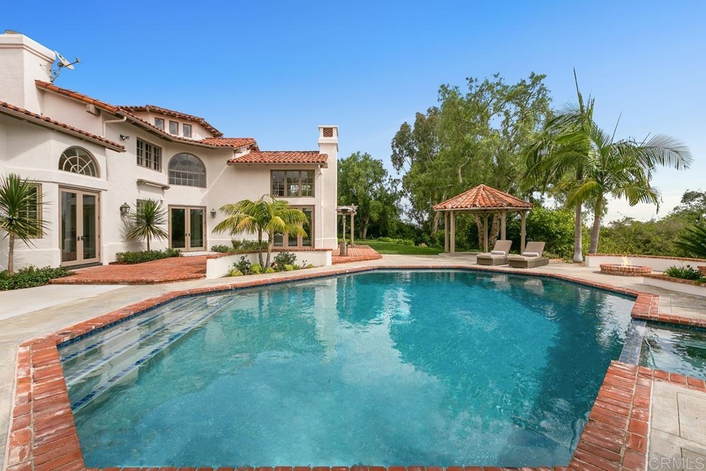 14910 Rancho Nuevo Del Mar, CA 92014 - Photo 39 of 54 a view of a swimming pool with a lawn chairs under an umbrella