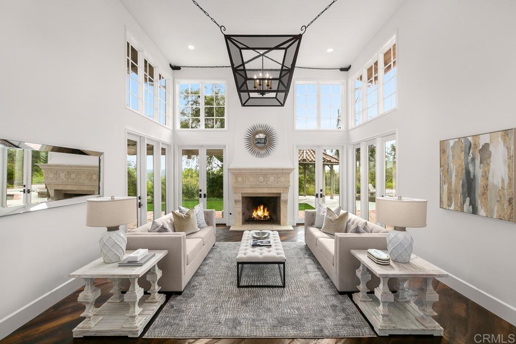 14910 Rancho Nuevo Del Mar, CA 92014 - Photo 7 of 54 a living room with furniture a fireplace and a chandelier