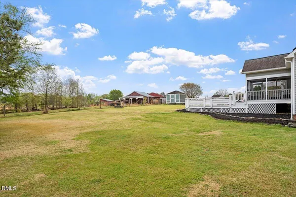 a front view of a house with swimming pool and trees
