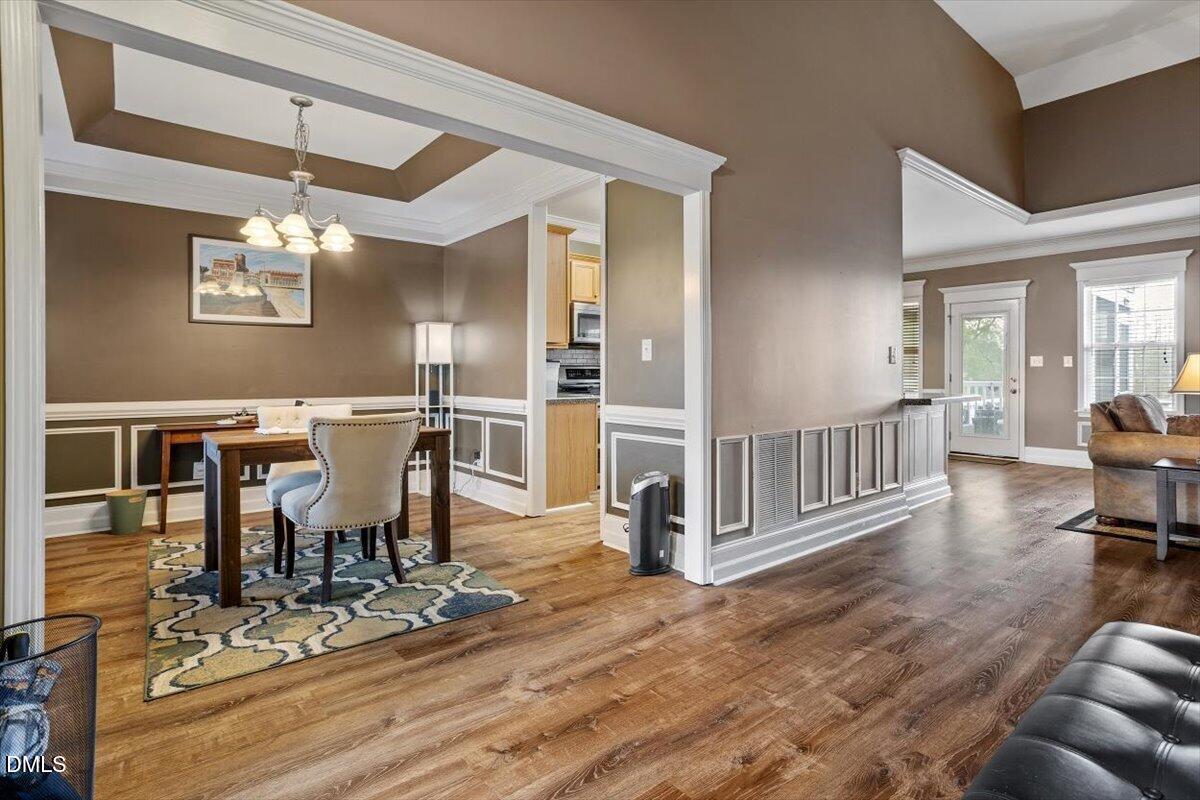 118 Victory Circle Willow Spring, NC 27592 - Photo 13 of 42 a view of a dining room with furniture a chandelier and wooden floor