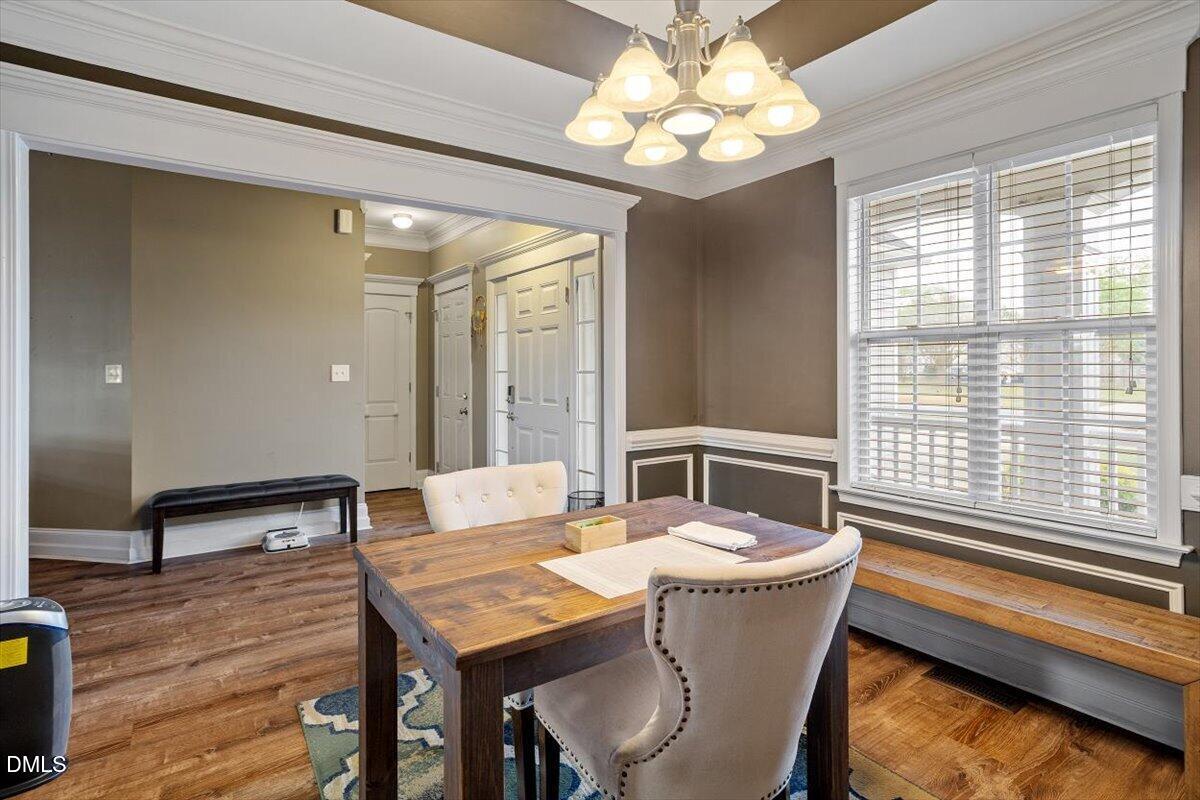 118 Victory Circle Willow Spring, NC 27592 - Photo 14 of 42 a dining room with a table chairs and wooden floor