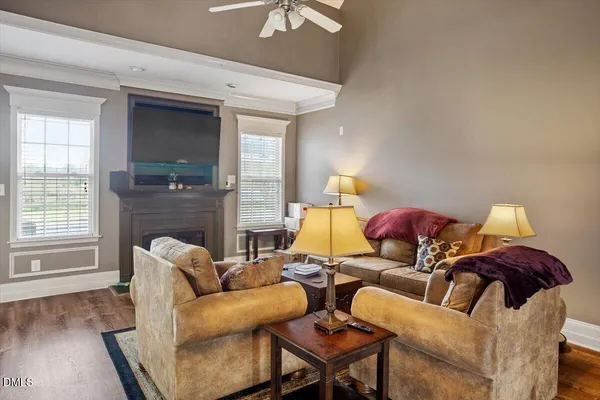 a view of a dining room with furniture a chandelier and wooden floor