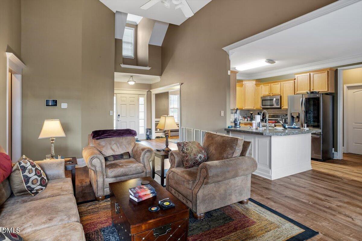 118 Victory Circle Willow Spring, NC 27592 - Photo 18 of 42 a living room with furniture fireplace and wooden floor