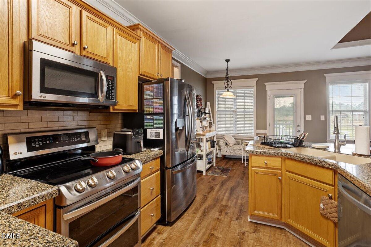 118 Victory Circle Willow Spring, NC 27592 - Photo 19 of 42 a kitchen with a stove a sink and a microwave