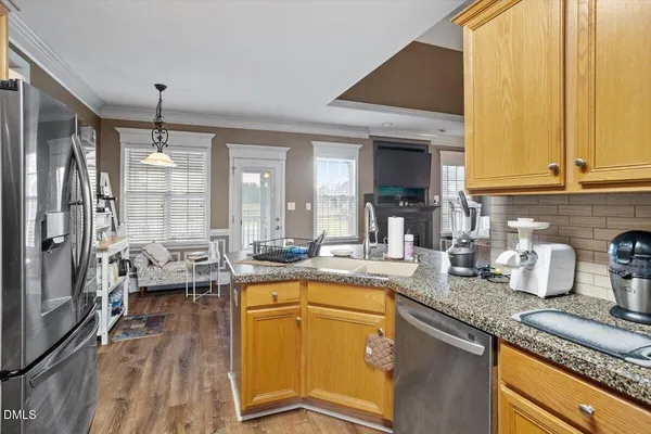 a living room with furniture fireplace and wooden floor