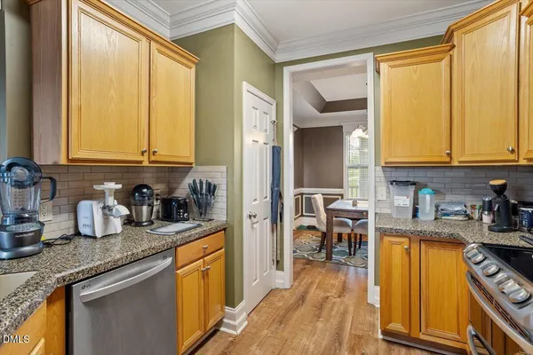 a kitchen with sink refrigerator and window