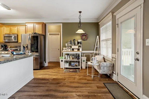 a kitchen with sink refrigerator and cabinets