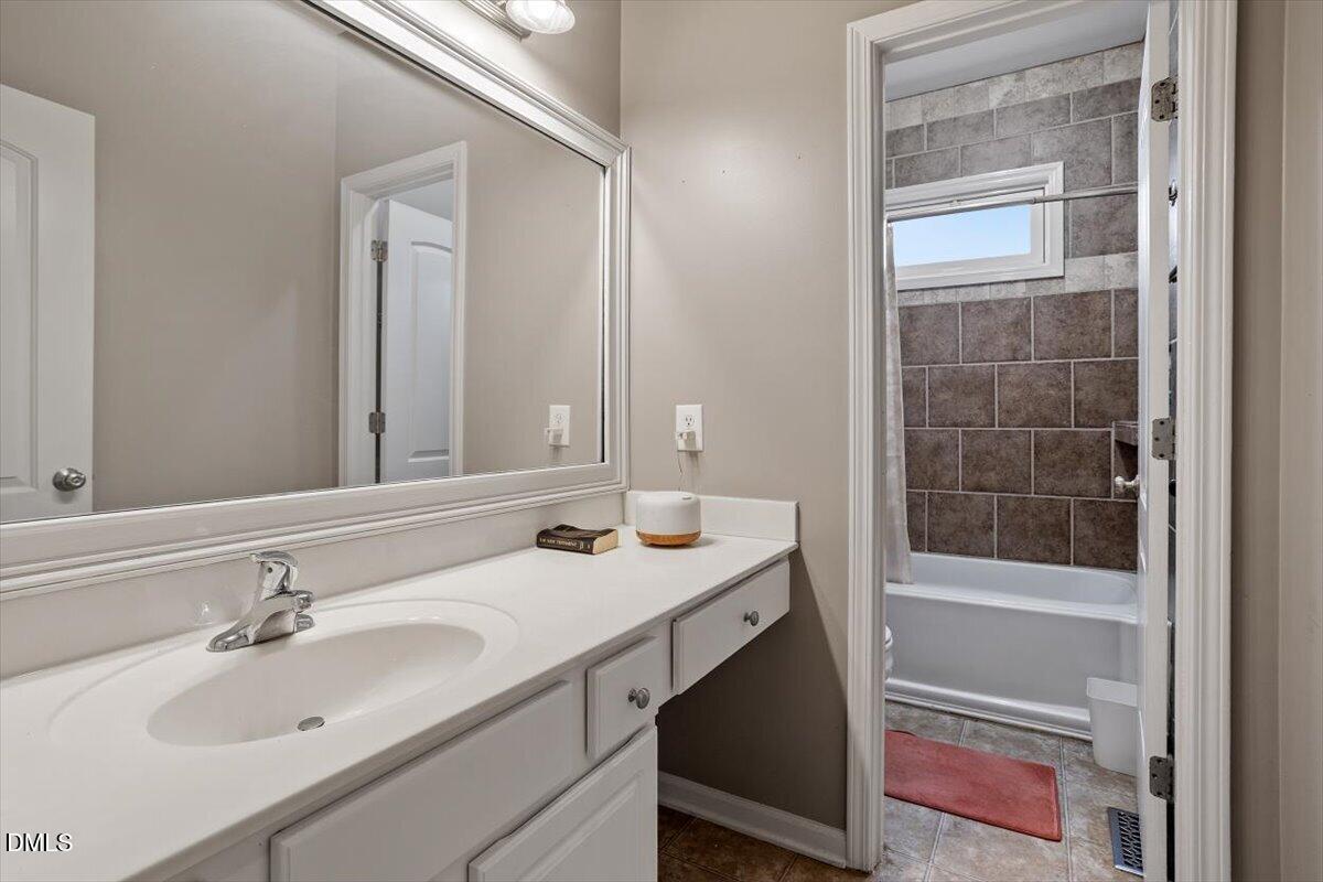 118 Victory Circle Willow Spring, NC 27592 - Photo 26 of 42 a bathroom with a sink and a mirror