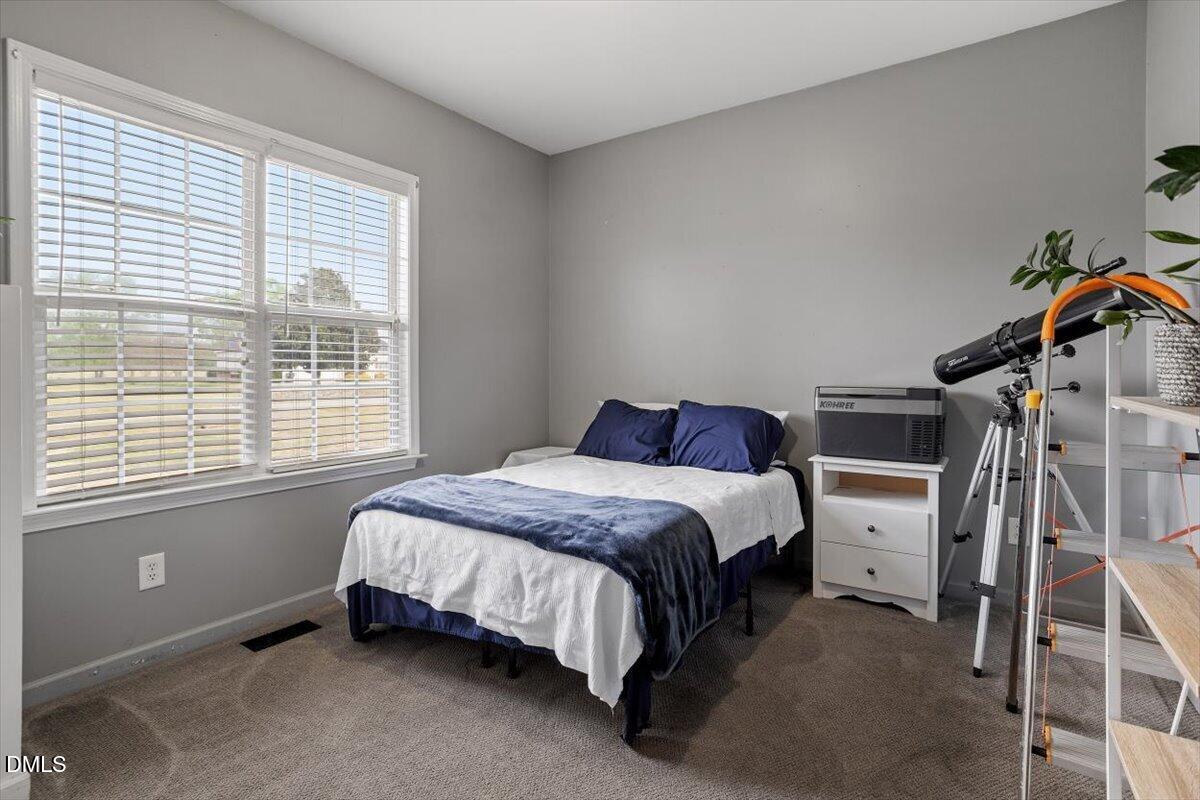 118 Victory Circle Willow Spring, NC 27592 - Photo 27 of 42 a spacious bedroom with a bed and a window