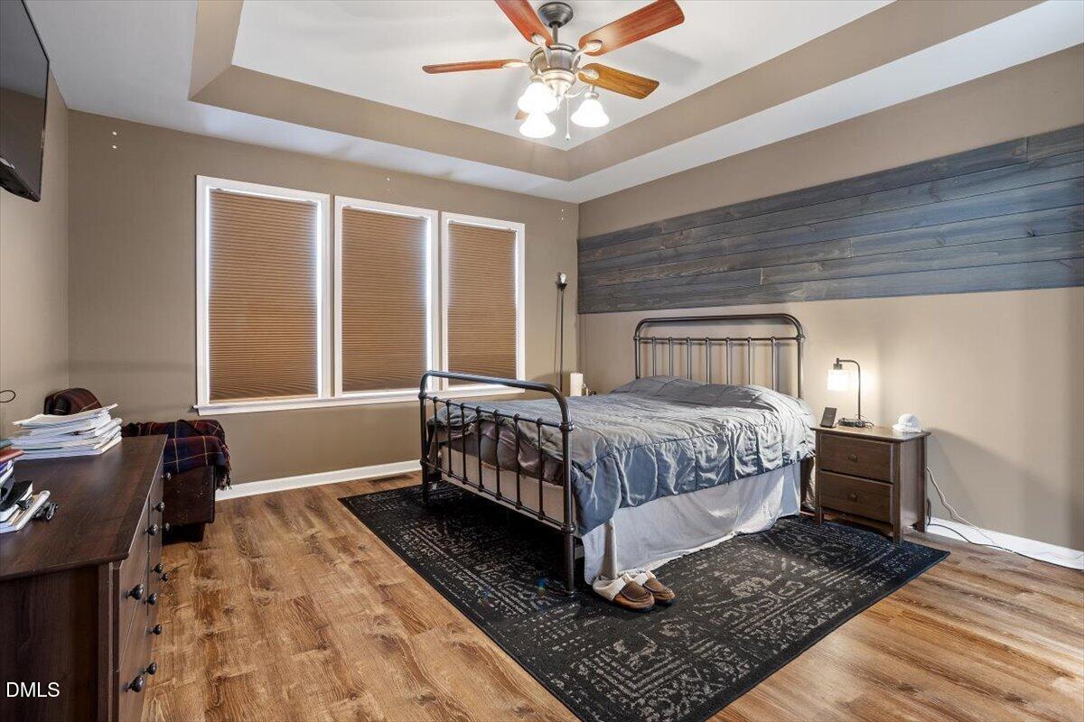 118 Victory Circle Willow Spring, NC 27592 - Photo 28 of 42 a bedroom with a bed and wooden floor