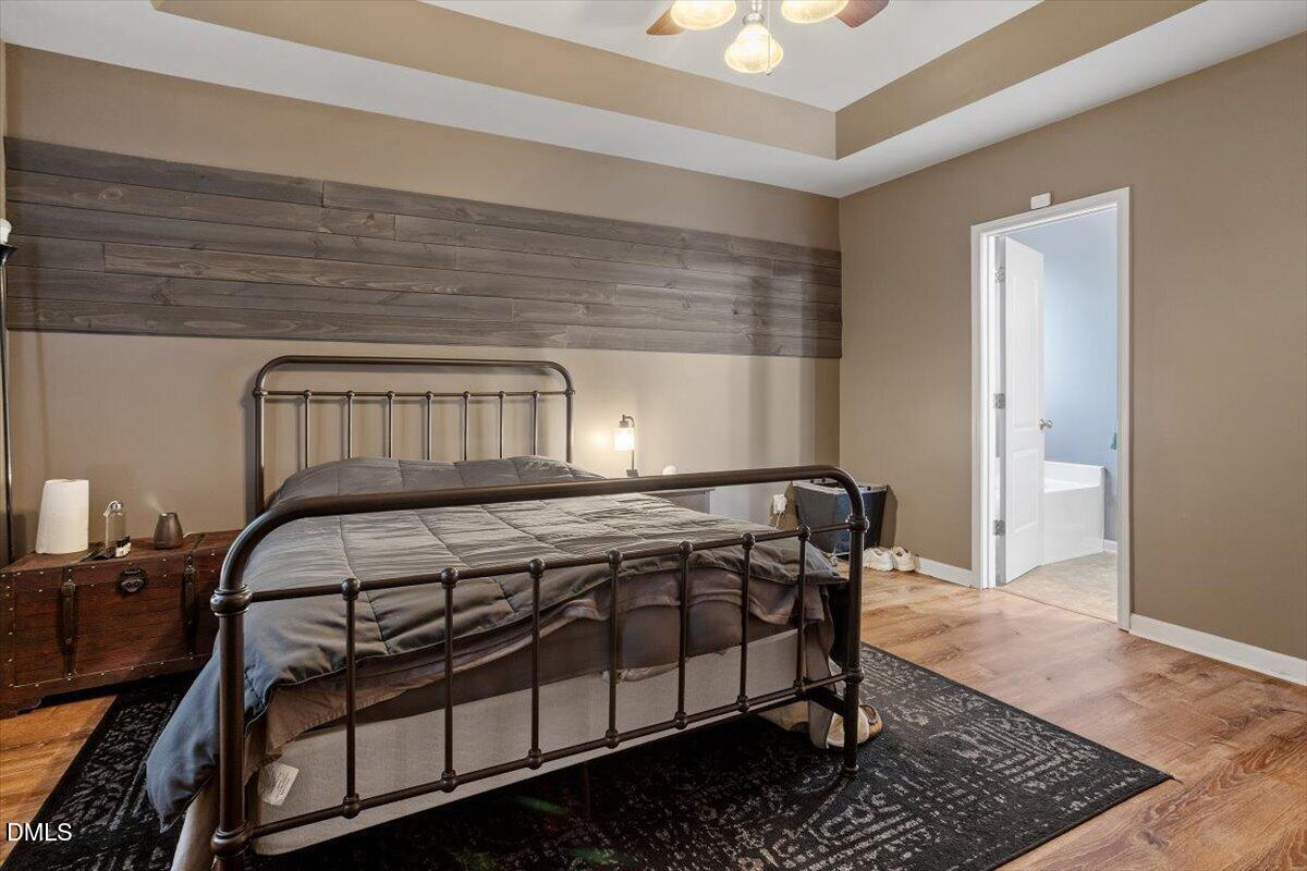 118 Victory Circle Willow Spring, NC 27592 - Photo 29 of 42 a bedroom with a bed and wooden floor