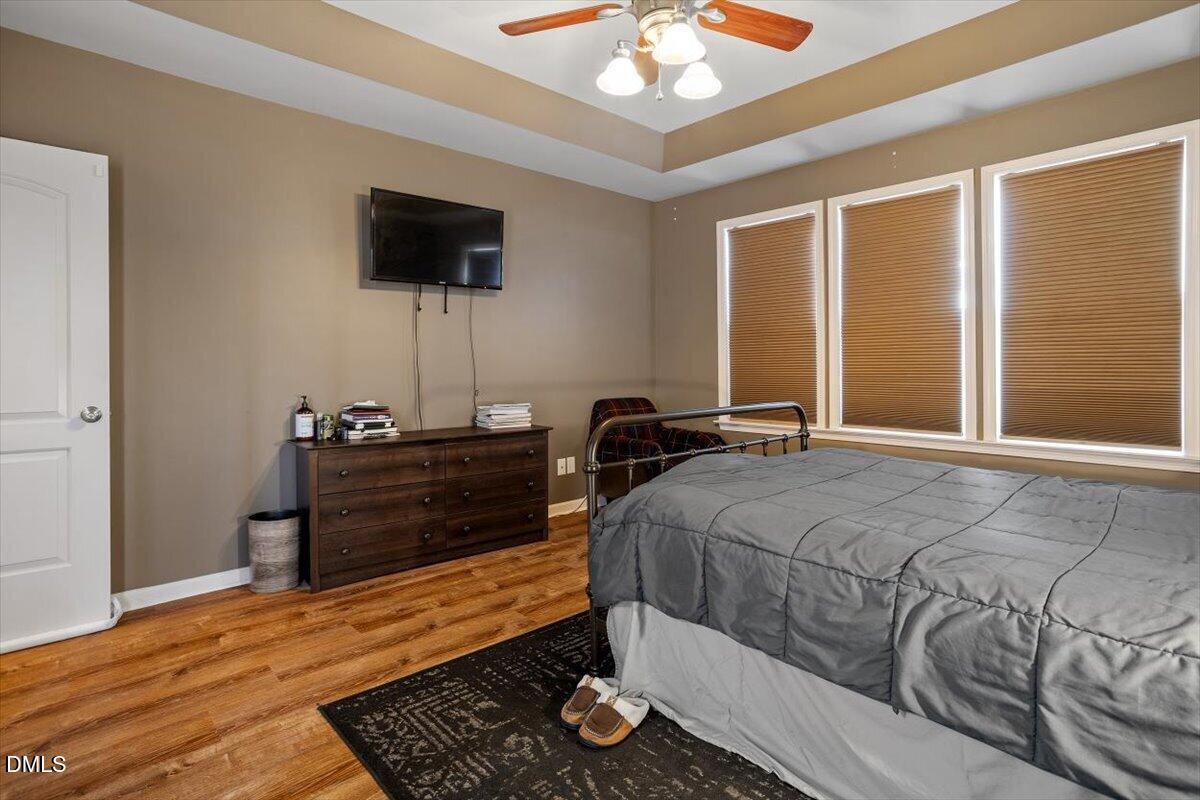 118 Victory Circle Willow Spring, NC 27592 - Photo 30 of 42 a bedroom with a bed and wooden floor