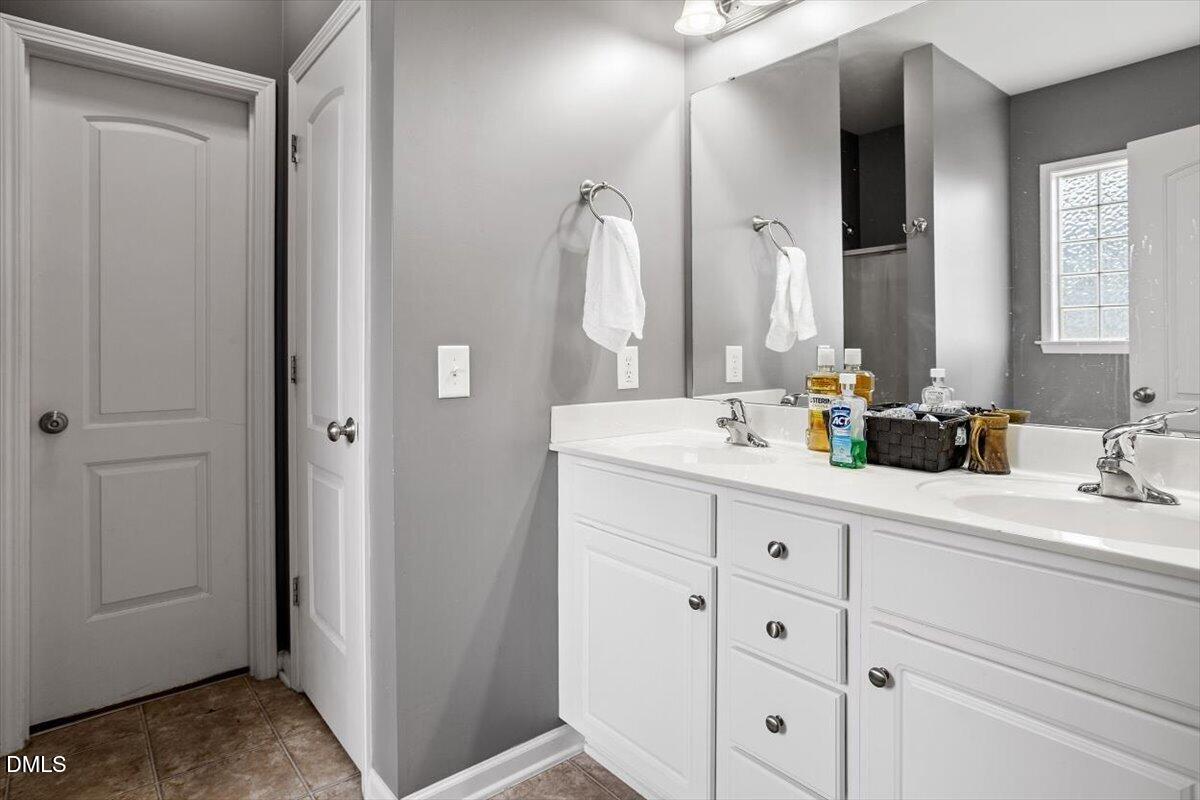 118 Victory Circle Willow Spring, NC 27592 - Photo 31 of 42 a bathroom with a double vanity sink and mirror