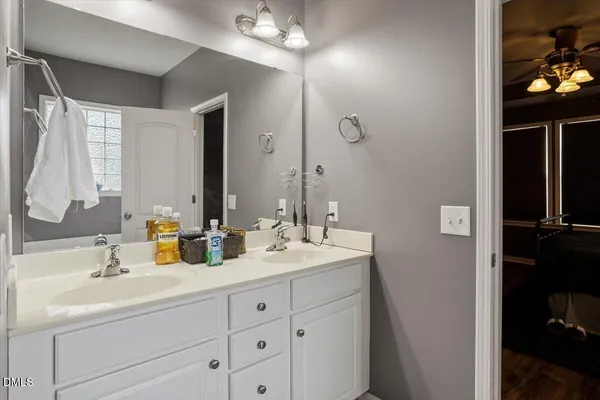 a bathroom with a double vanity sink and mirror