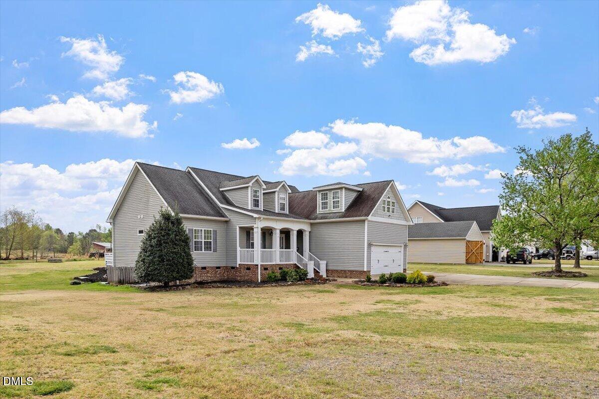 118 Victory Circle Willow Spring, NC 27592 - Photo 3 of 42 a front view of a house with a ocean view