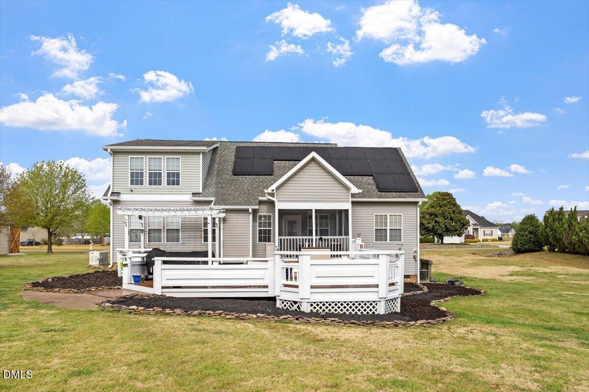 118 Victory Circle Willow Spring, NC 27592 - Photo 5 of 42 a front view of a house with swimming pool and trees