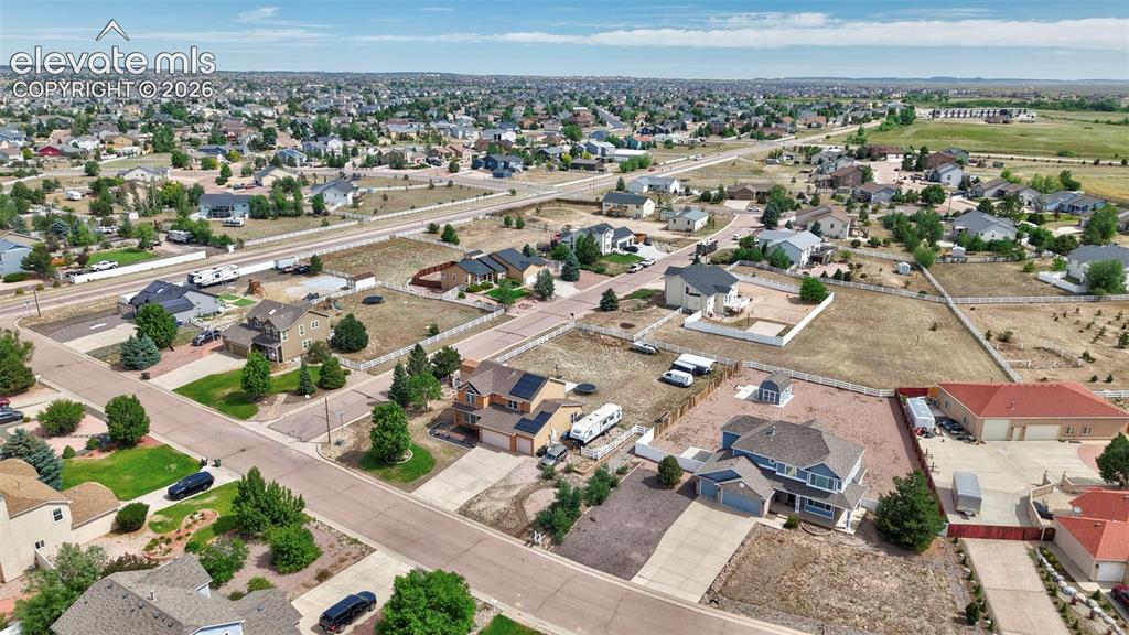 8347 Tibbs Road Peyton, CO 80831 - Photo 32 of 39 Expansive residential area featuring a variety of single-family homes, mature landscaping, and paved roads