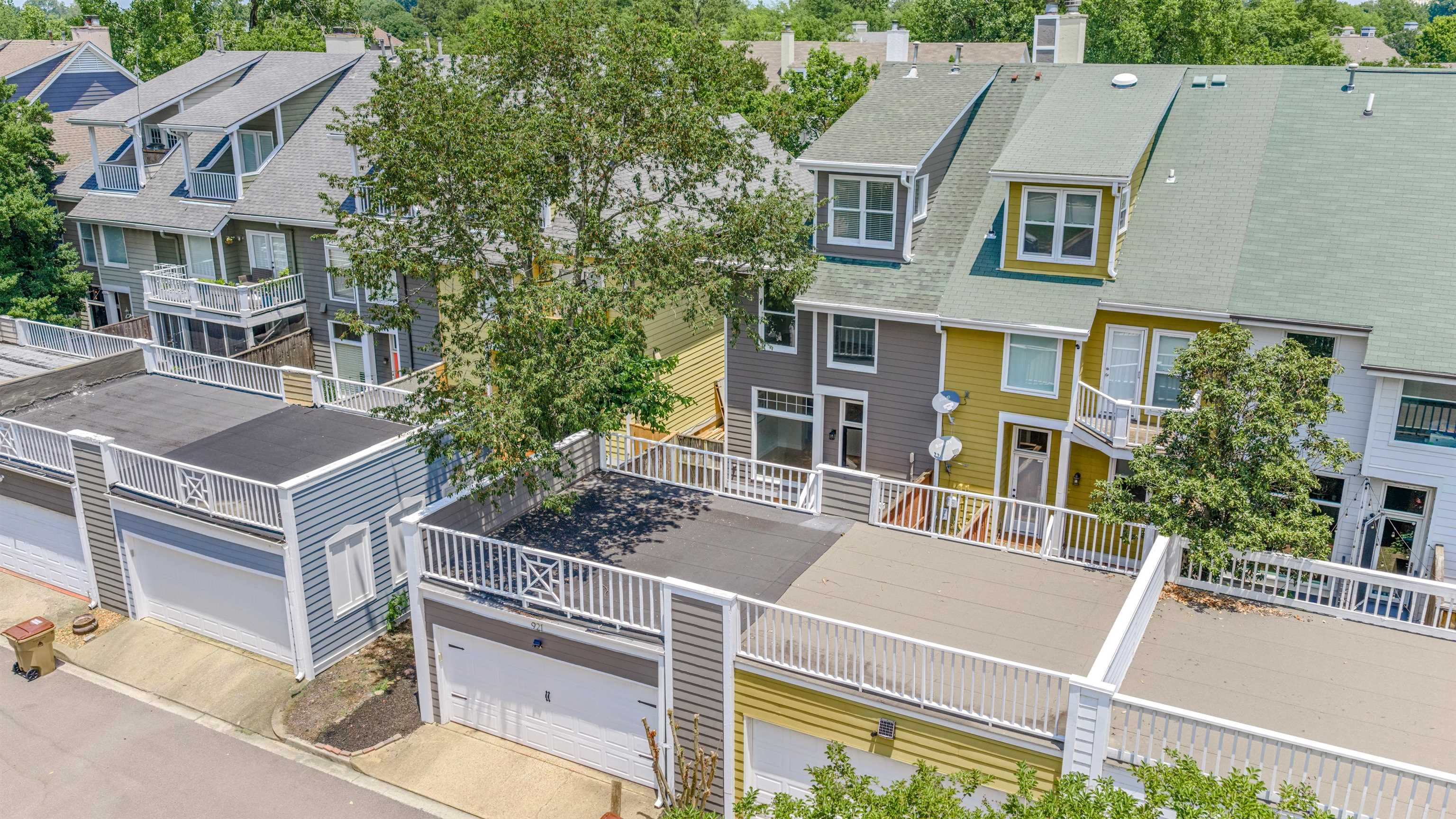 921 Harbor View Drive Memphis, TN 38103 - Photo 2 of 33 Row of townhomes featuring multi-level facades, integrated garages with overhead doors, and upper-level balconies with white railings
