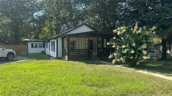 a front view of a house with yard and green space