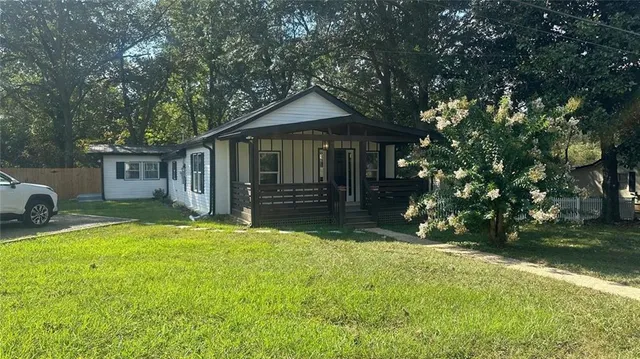 a front view of a house with yard and green space