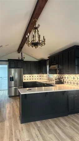 a kitchen with stainless steel appliances granite countertop a sink and cabinets