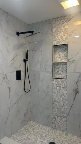 a bathroom with a toilet and a shower