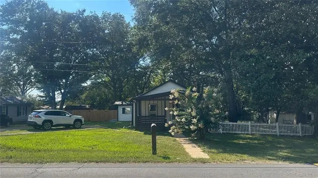 a front view of house with yard and green space