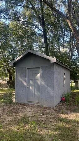 a view of a small house with a yard