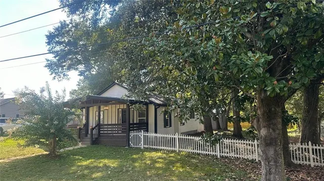 a backyard of a house with table and chairs