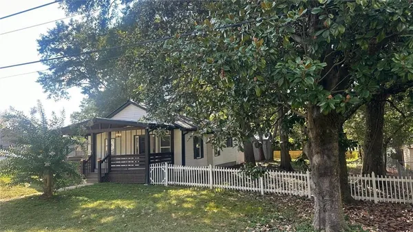 a view of a house with a yard porch and sitting area