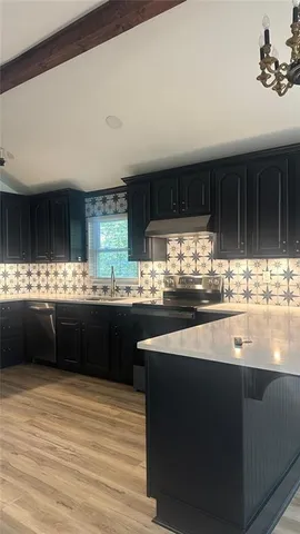 a kitchen with stainless steel appliances granite countertop a sink counter space and cabinets