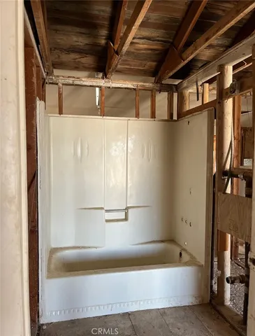 a view of a room with wooden door