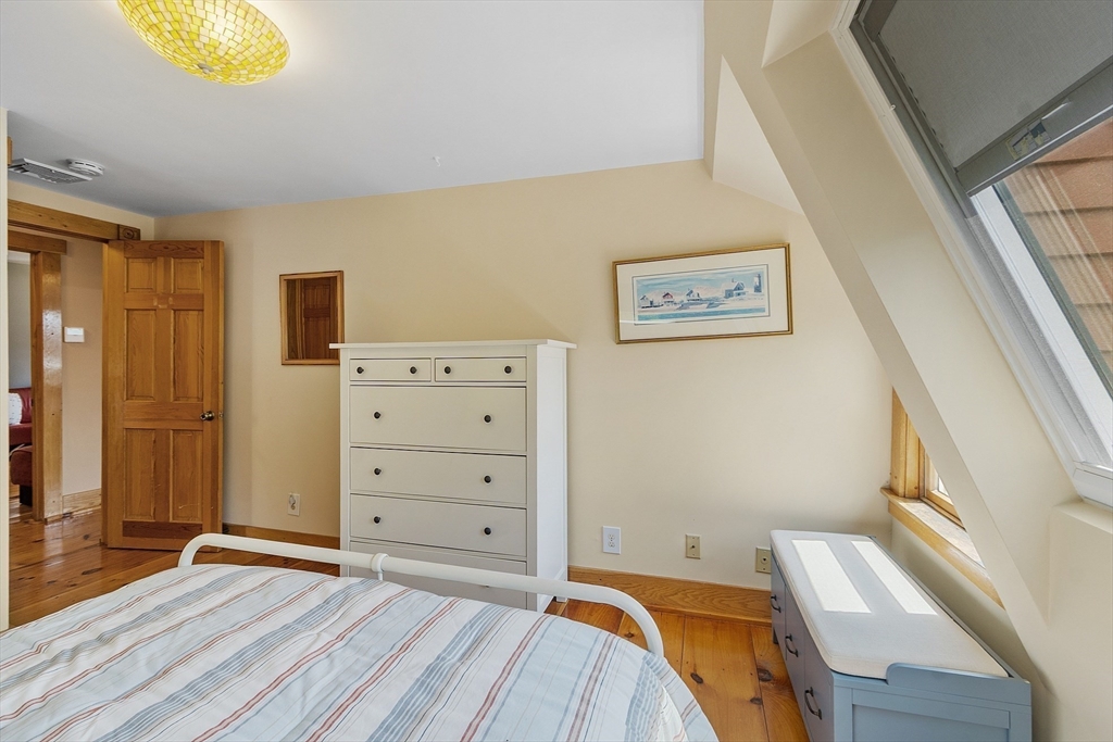 205 R Western Avenue Gloucester, MA 01930 - Photo 15 of 30 a view of a bedroom with bed and cabinets