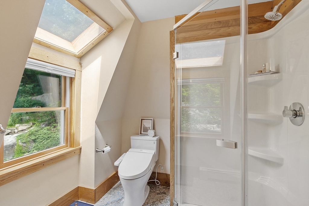 205 R Western Avenue Gloucester, MA 01930 - Photo 18 of 30 a bathroom with a toilet a sink and a large window