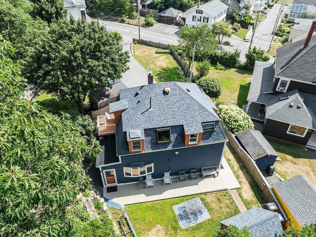205 R Western Avenue Gloucester, MA 01930 - Photo 28 of 30 an aerial view of a house with swimming pool and large trees
