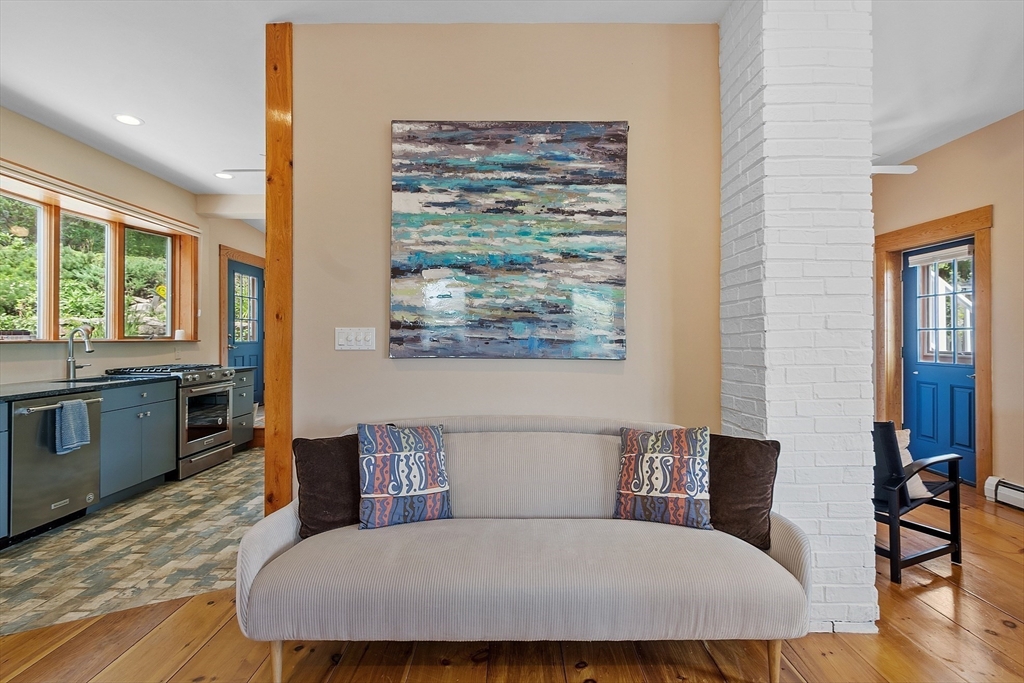 205 R Western Avenue Gloucester, MA 01930 - Photo 8 of 30 a bedroom with a large bed and a table chair