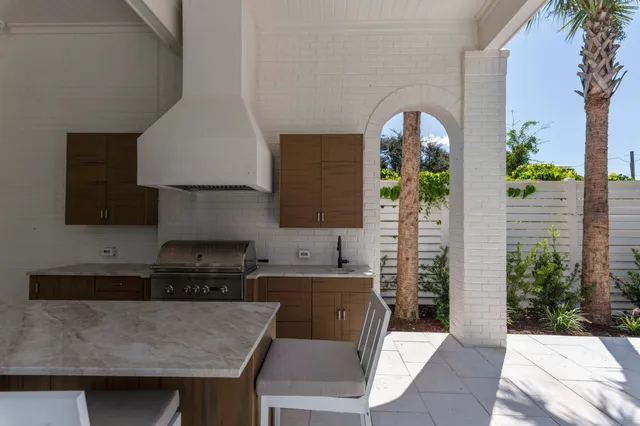 a large kitchen with a table and chairs
