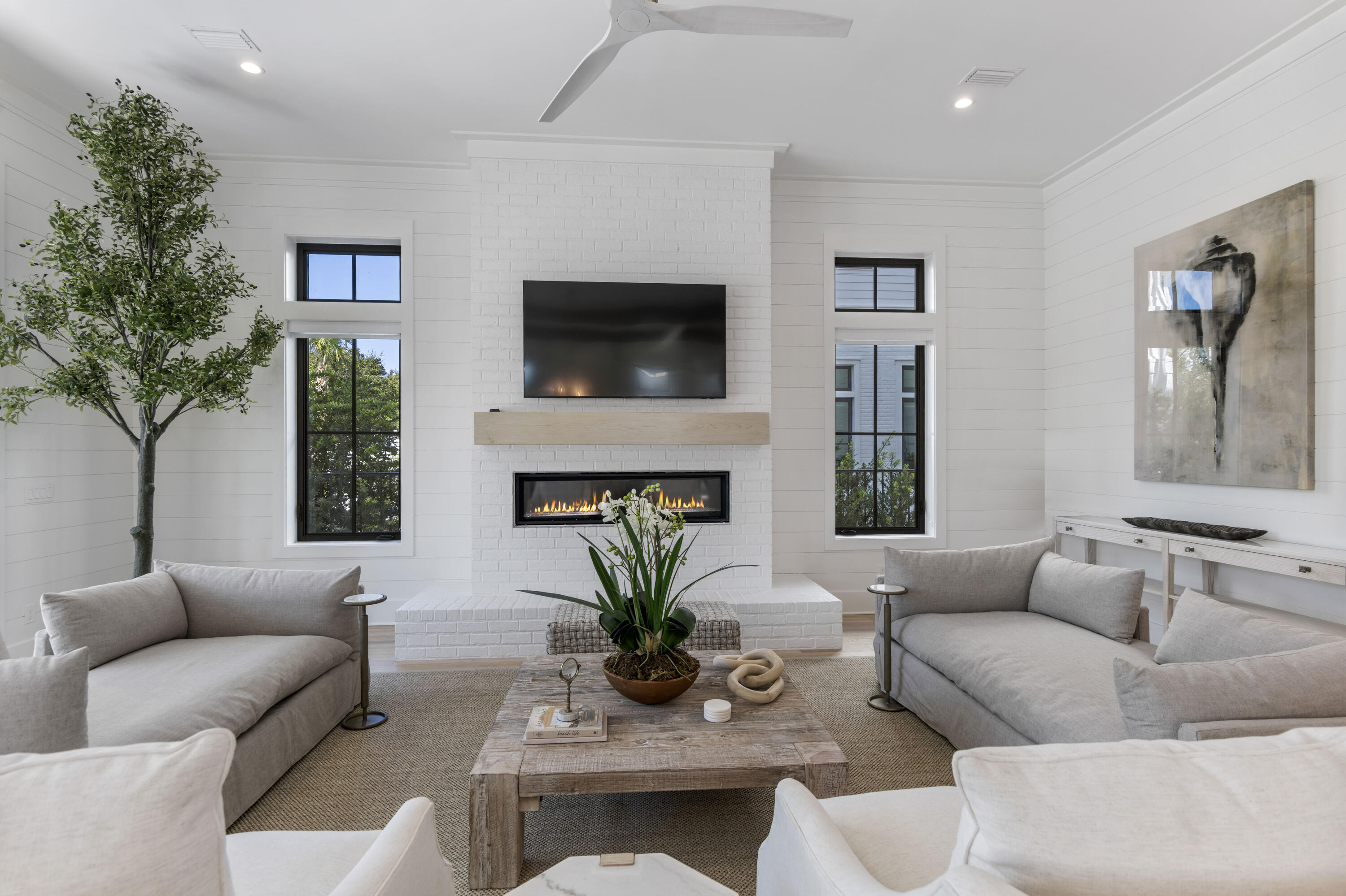 140 South Wall Street Inlet Beach, FL 32461 - Photo 24 of 82 a living room with furniture a flat screen tv and a fireplace
