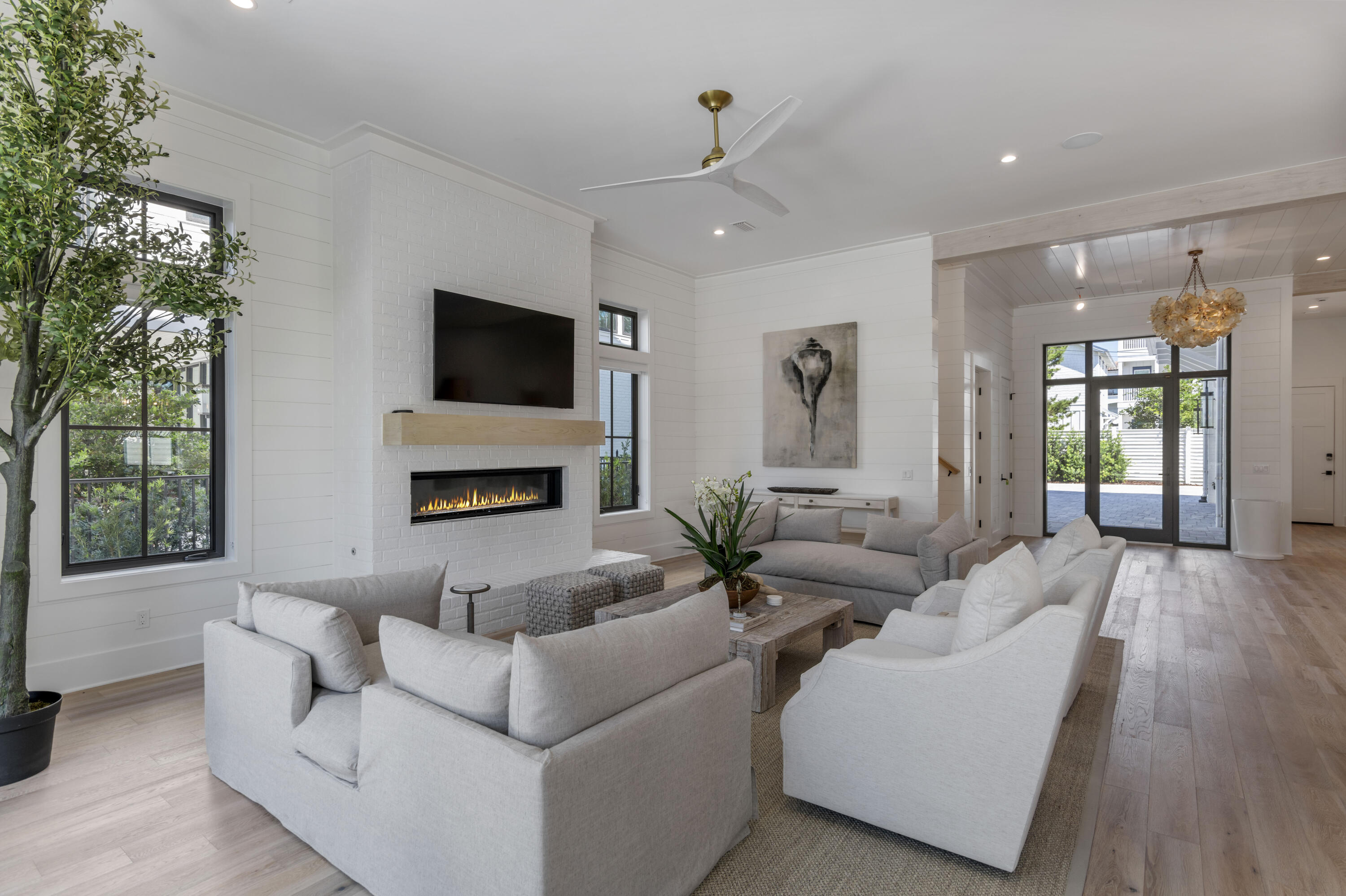 140 South Wall Street Inlet Beach, FL 32461 - Photo 26 of 85 a living room with furniture a flat screen tv and a fireplace