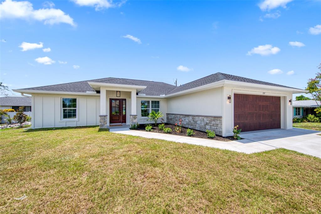 237 Holly Road Venice, FL 34293 - Photo 1 of 1 a view of a house with a yard and garage