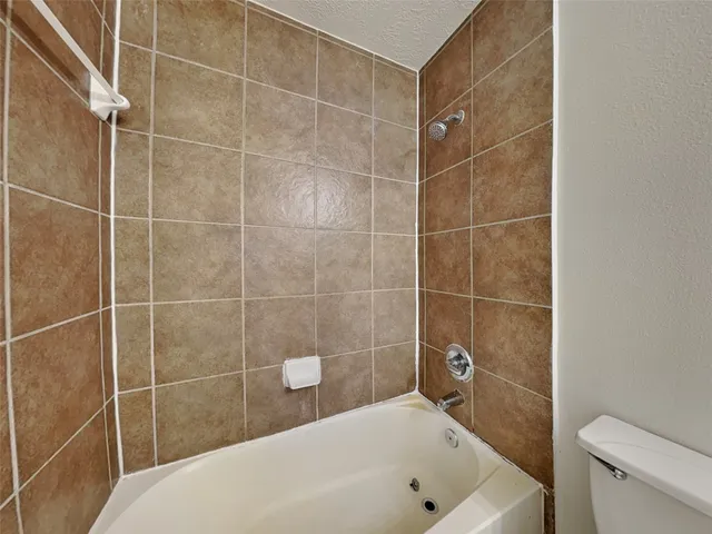 a bathroom with a bathtub and toilet