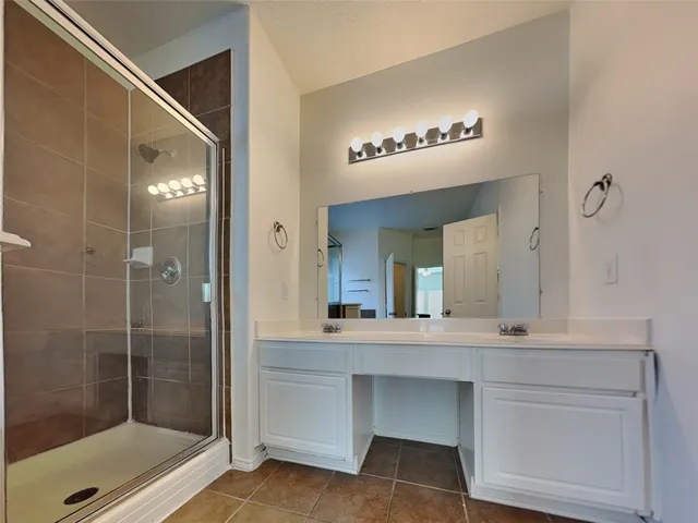 a bathroom with a sink a mirror and shower