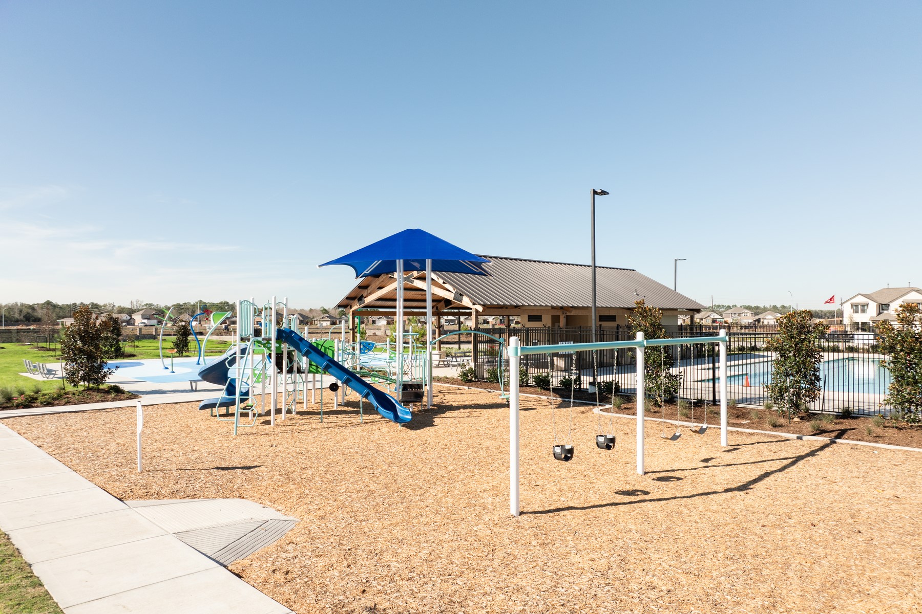 8946 Ice Quartz Drive Iowa Colony, TX 77583 - Photo 14 of 15 a view of a swimming pool with a bench and lawn chairs