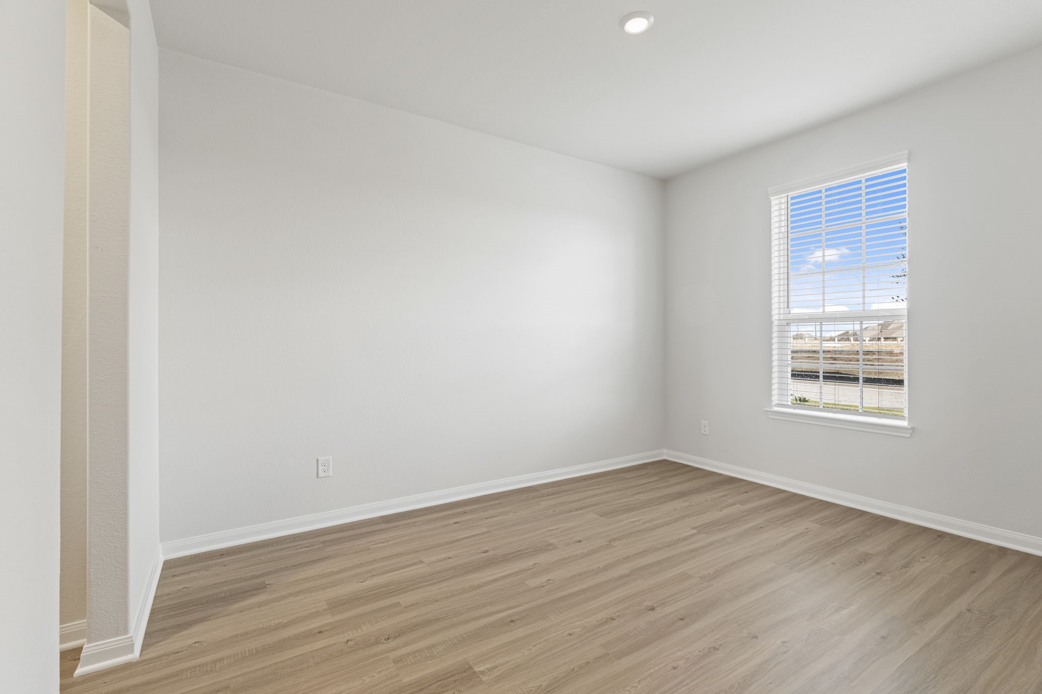 8946 Ice Quartz Drive Iowa Colony, TX 77583 - Photo 2 of 15 an empty room with wooden floor and windows