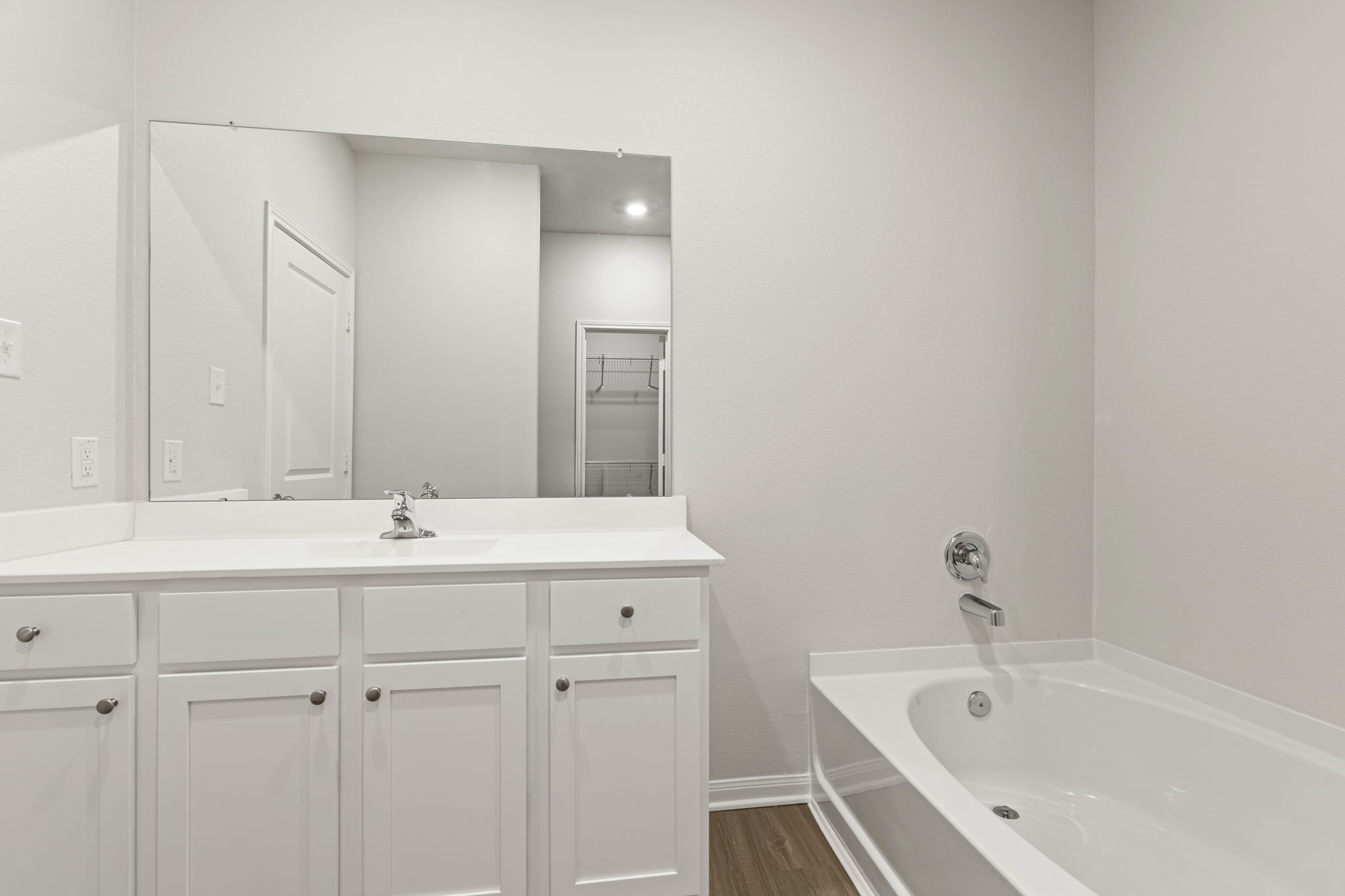 8946 Ice Quartz Drive Iowa Colony, TX 77583 - Photo 7 of 15 a bathroom with a bathtub and a sink